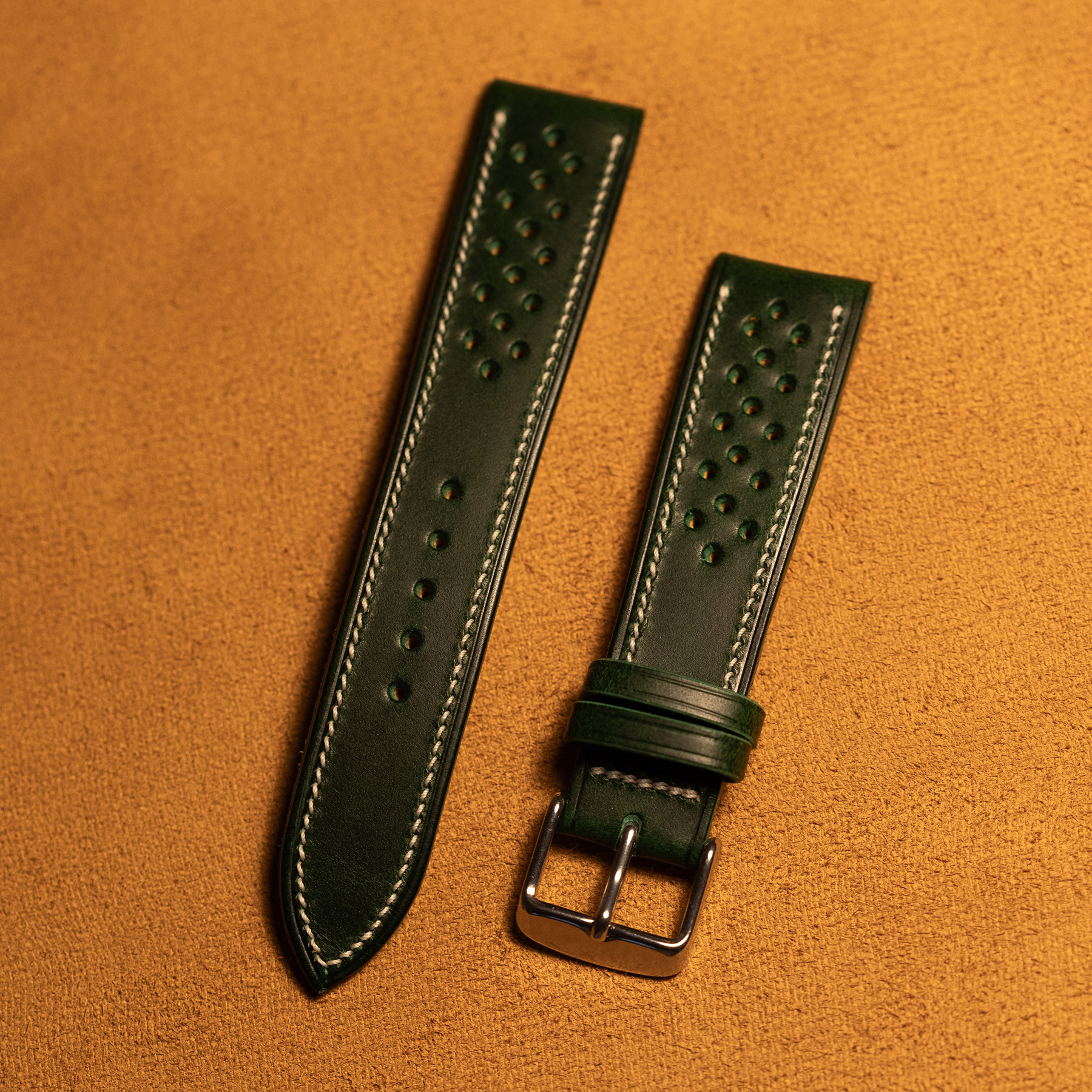 Macro detail of the signature mirrored microstitch on a handmade watch strap